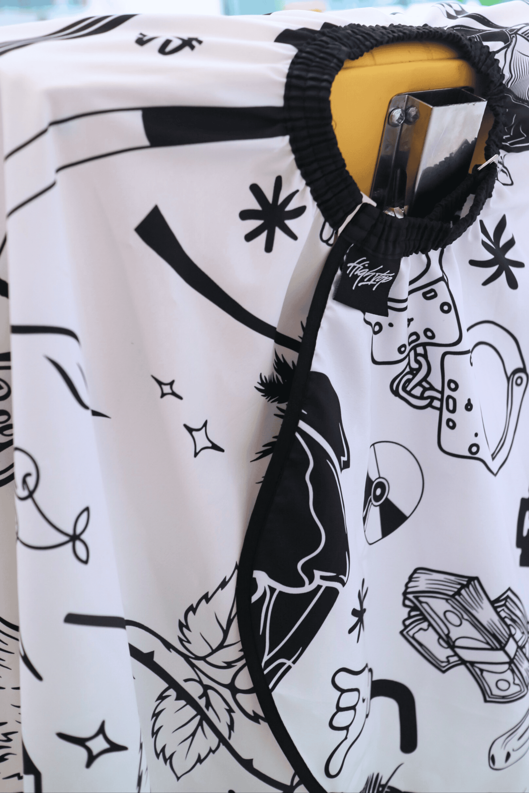 close up of Club cape elastic neck barber cape using hook closure