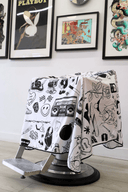 tattoo barber cape in barbershop draped on barber chair