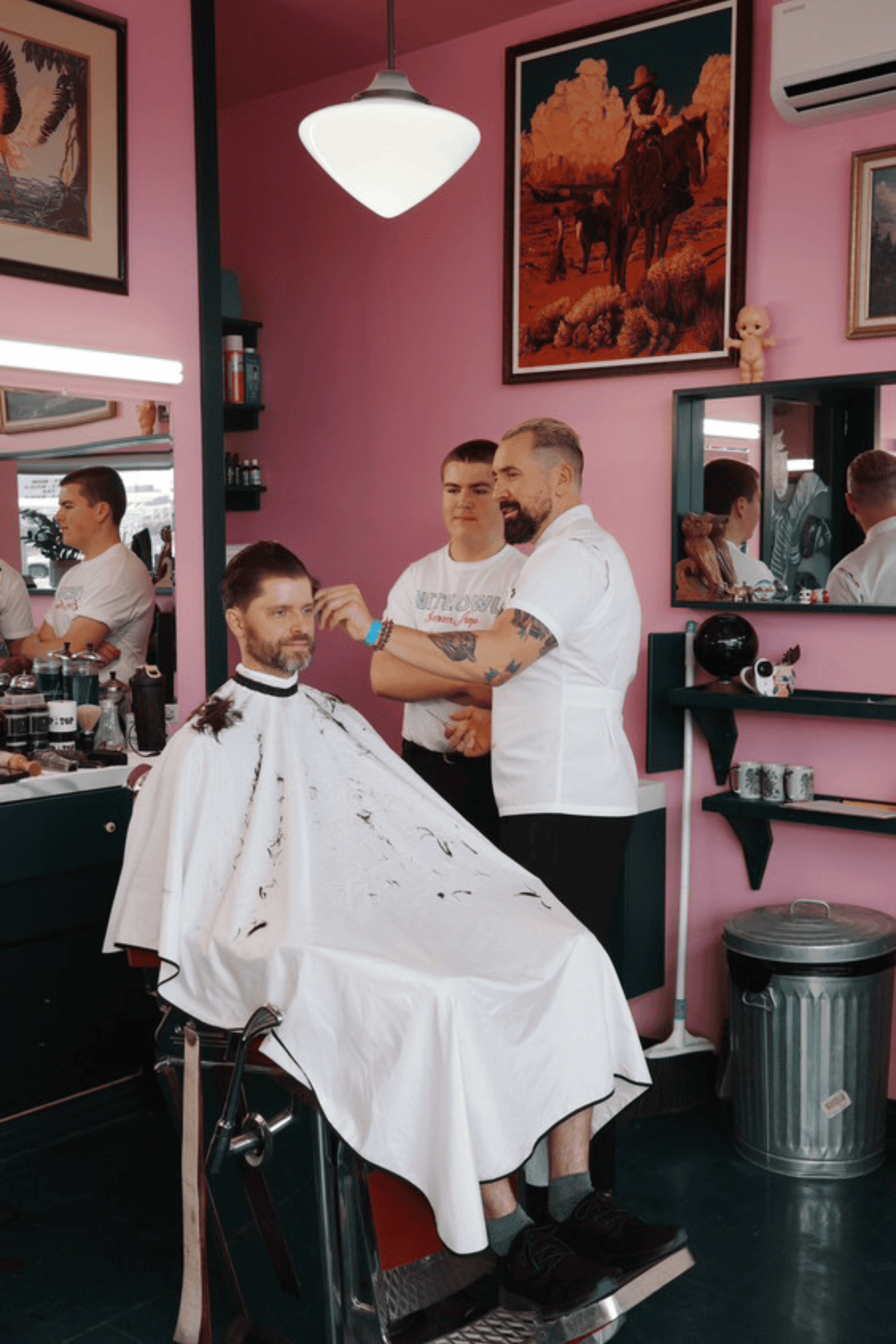 sage colored barber cutting cape draped on barber chair inside a barbershop