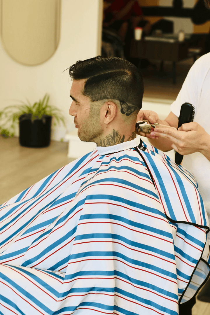 Photo of a customer wearing Blood and Bandages while barber cuts their hair