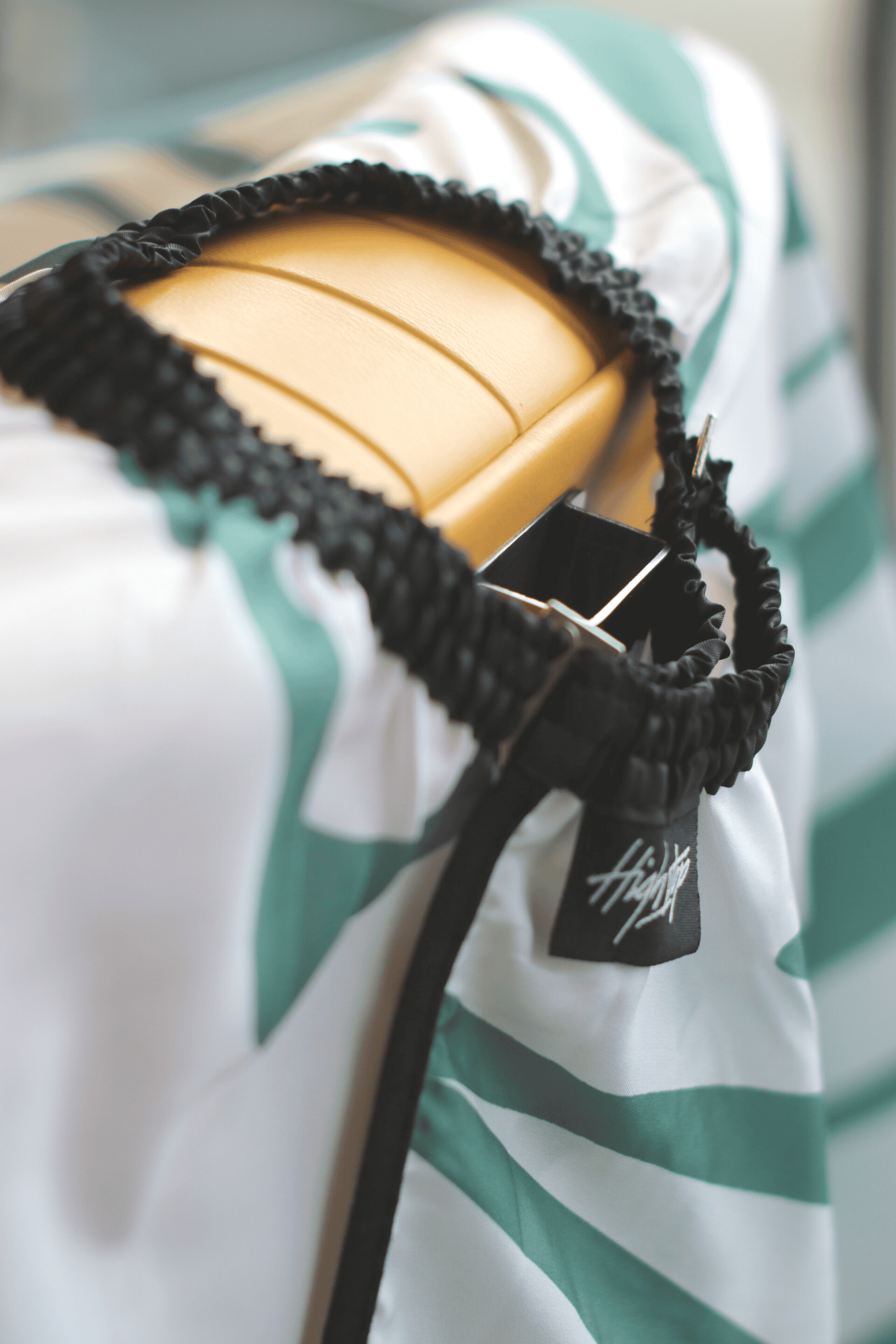 Close-up view of the elastic neck band and hook neck closure on the Aurora Cape by High Top Capes